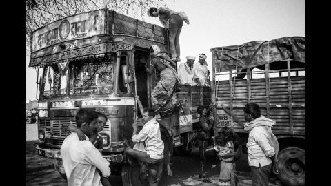 Every year, thousands of farmers and landless farm workers from the Marathwada region migrate to western Maharashtra and neighboring Karnataka to harvest sugarcane for the mills there, usually for a period of six months. Here, migrants returning from Karnataka transfer to smaller vehicles in Dharur before traveling back to their respective villages.