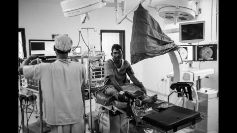 Baliram Jadhav, a 40-year-old farmer, waits on the operating table for anesthesia before a surgery to remove kidney stones in Latur. Jadhav blames the stones on the water he had been drinking water from a borewell, which he says is more alkaline than the water he used to drink from his well, which dried up two years ago. He lived with the pain for two years until he finally borrowed money for a procedure.
