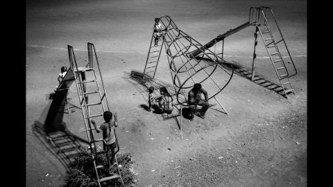 The lack of work in villages during the summer months has forced many farmer families to migrate to cities such as Mumbai, Pune and Hyderabad. Here, a migrant family from Nanded, India, spends an evening at a Mumbai playground, just outside an open ground where a number of families have set up camp.