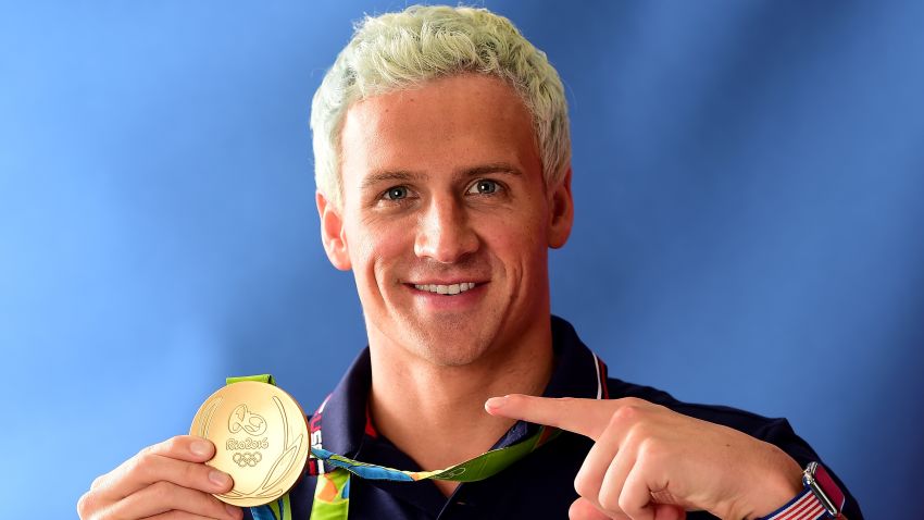 RIO DE JANEIRO, BRAZIL - AUGUST 12:  (BROADCAST - OUT) Swimmer, Ryan Lochte of the United States poses for a photo with his gold medal on the Today show set on Copacabana Beach on August 12, 2016 in Rio de Janeiro, Brazil.  (Photo by Harry How/Getty Images)