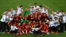 Germany's players, coaches and officials celebrate after their team's victory over Sweden after the Rio 2016 Olympic Games women's football final.