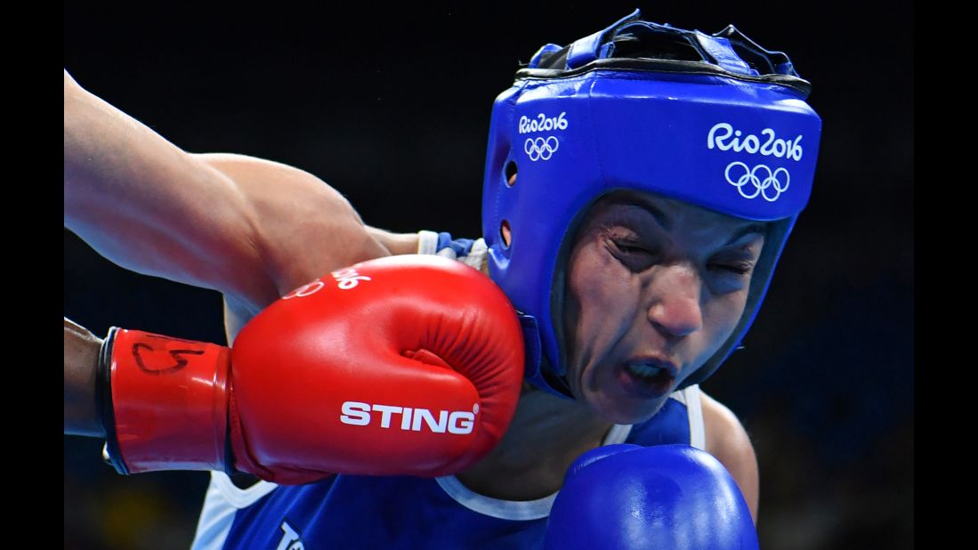 British boxer Nicola Adams, left, punches Sarah Ourahmoune of France during their flyweight 51-kilogram (112-pound) final bout.