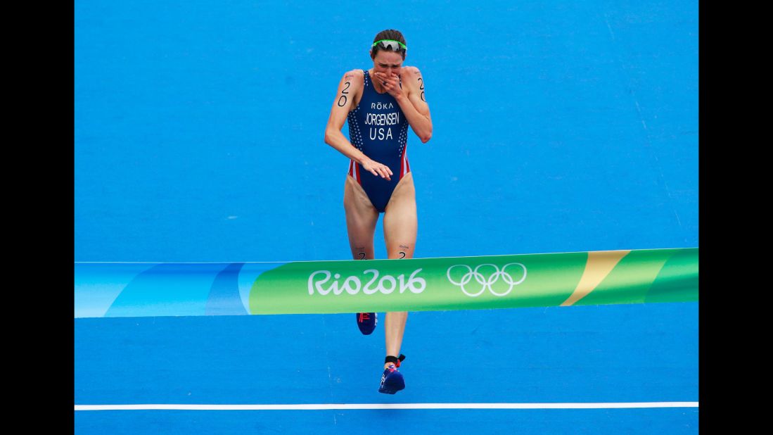 U.S. triathlete Gwen Jorgensen reacts as she crosses the finish line. This is the first time the United States has won gold in the triathlon.