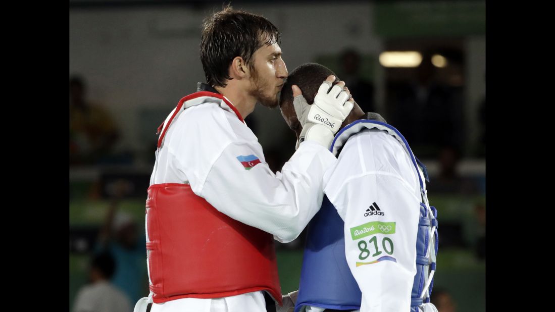 Radik Isaev of Azerbaijan, left, kisses Great Britain's Mahama Cho after defeating Cho in the over 80-kilogram (176-pound) semifinal taekwondo event. 