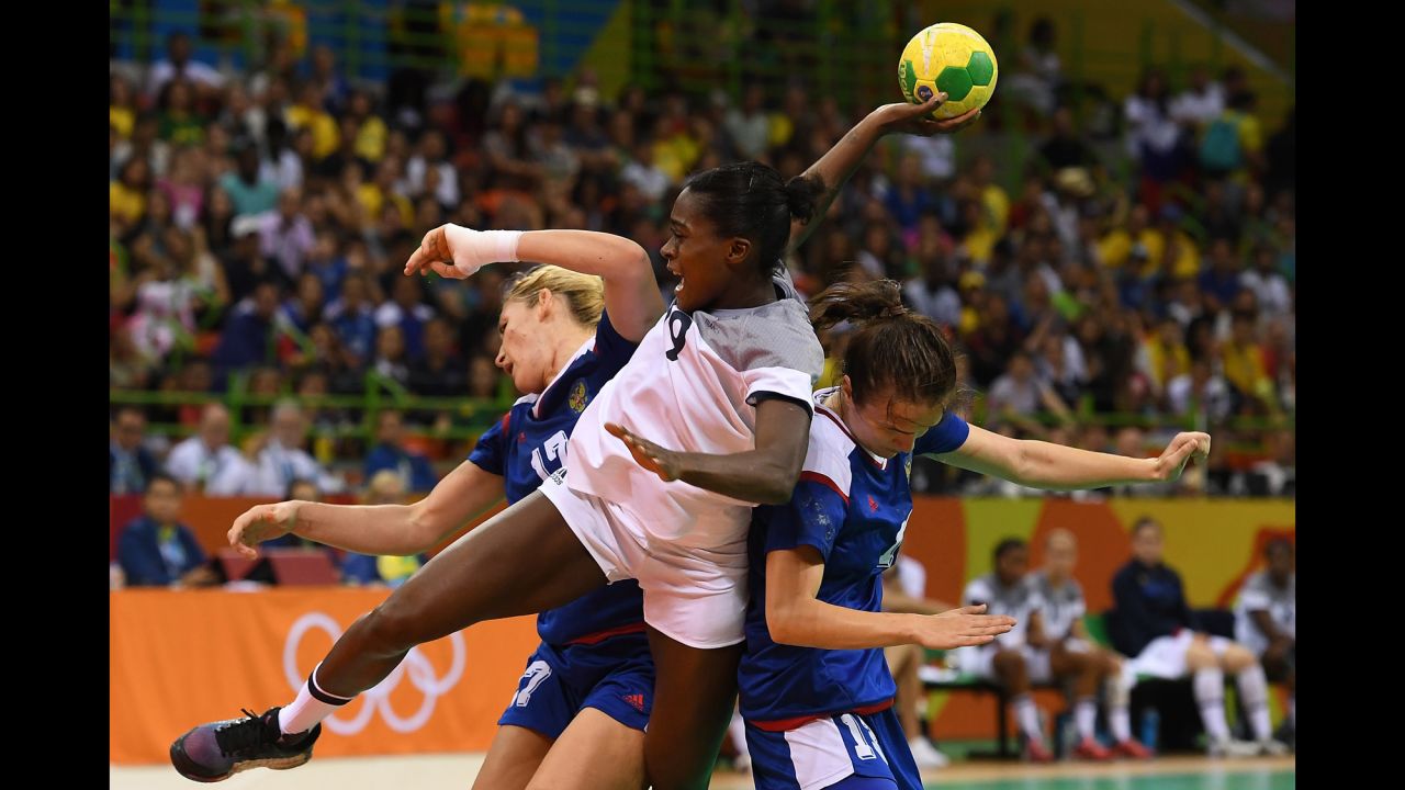French handball player Gnonsiane Niombla, center, shoots the ball during the gold medal match against Russia. The Russians came out on top.