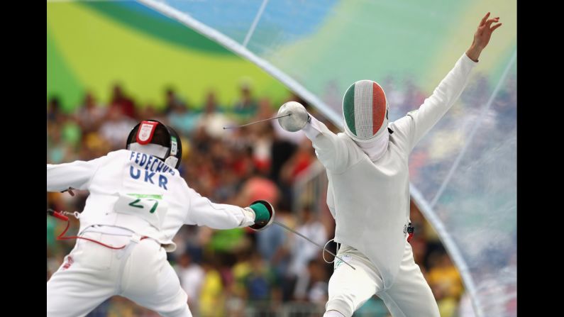 Ukraine's Andriy Fedechko, left, and Ireland's Arthur Lanigan-O'Keeffe take part in the fencing round of the modern pentathlon.