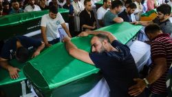 A man lays on a coffin as mourners gather during a funeral for victims of the Saturday attack on a wedding party that left 50 dead in Gaziantep, Turkey on August 21.