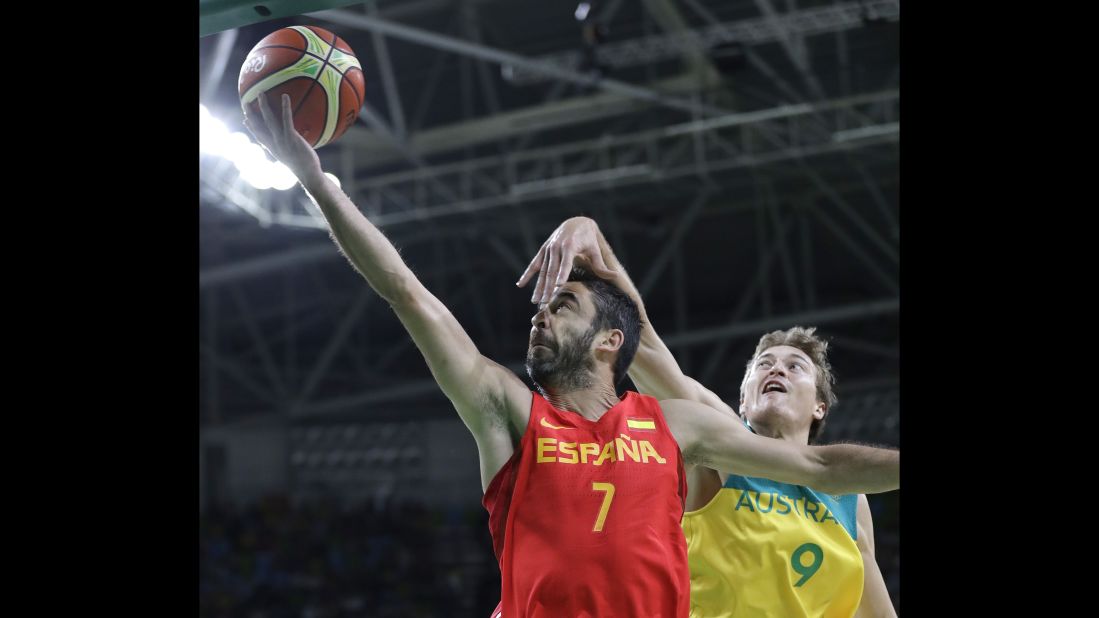 Spain's Juan Carlos Navarro, left, goes for the basket against Ryan Broekhoff of Australia during their bronze medal basketball game. The Spaniards won 89-88.