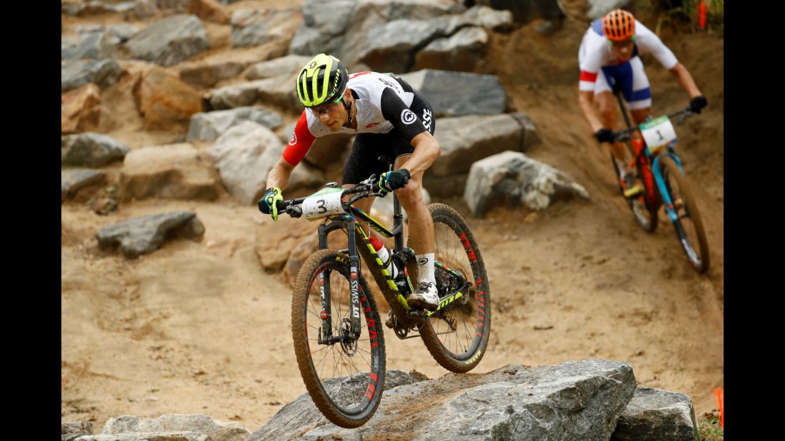 Swiss cyclist Nino Schurter, left, and Jaroslav Kulhavy of the Czech Republic take part in the cross-country mountain bike race. Schurter and Kulhavy earned gold and silver, respectively, while Spain's Carlos Coloma Nicolas finished with the bronze.