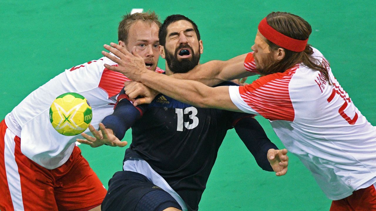 France's Nikola Karabatic, center, vies with Denmark's Henrik Toft Hansen and Mikkel Hansen during their gold medal handball match. The Danish came out on top, defeating the French 28-26.