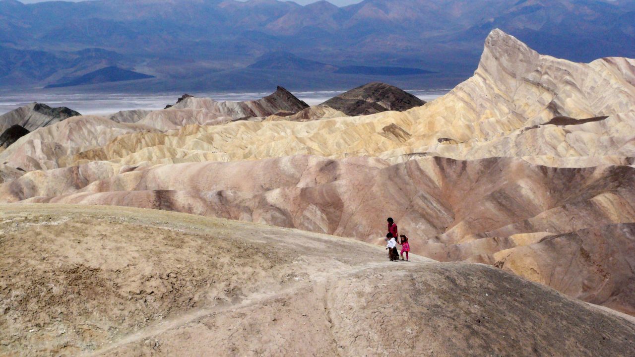 Tourists walk along a ridge at Death Valley National Park in California. Located about two hours west of Las Vegas along the California-Nevada state line, Death Valley is the lowest point in the Western Hemisphere.