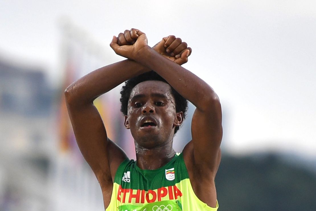 Ethiopia's Feyisa Lilesa crossed his arms above his head at the finish line.
