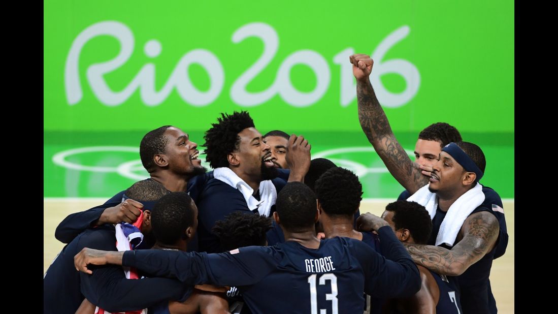 The U.S. basketball team celebrates after defeating Serbia in the gold medal game on Sunday, August 21. The Americans' victory marks their third straight Olympic gold.