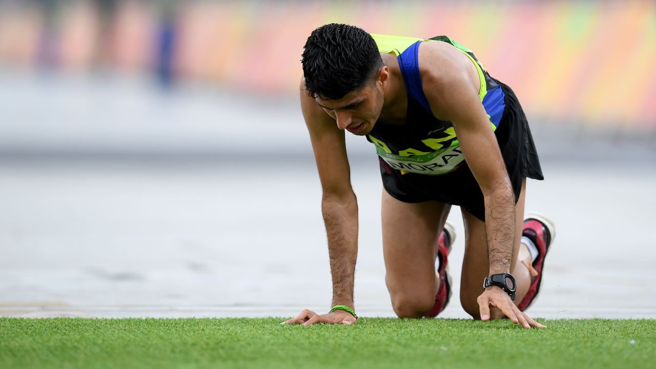 Iran's Mohammad Jafar Moradi struggles to finish the marathon.