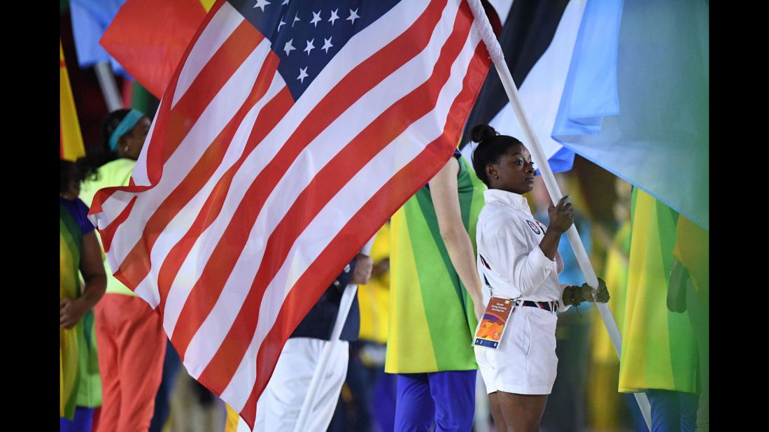 US gymnast Simone Biles holds the American flag.