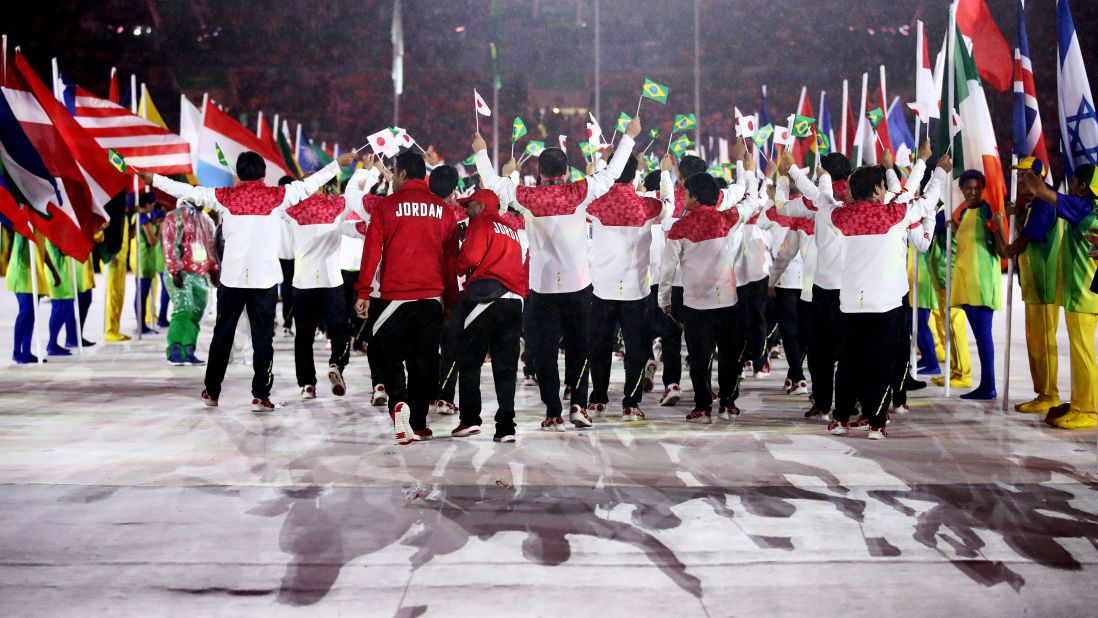 Athletes walk through the stadium.