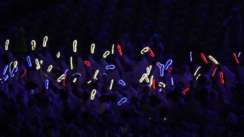 Members of Team Great Britain hold up their illuminated shoes.