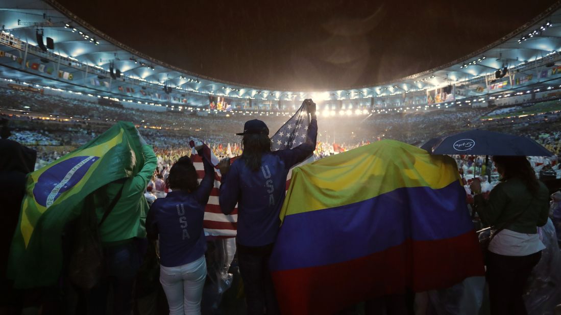 People wave flags from Brazil, the United States and Colombia during the Olympics closing ceremony at Maracana stadium in Rio de Janeiro on Sunday, August 21.