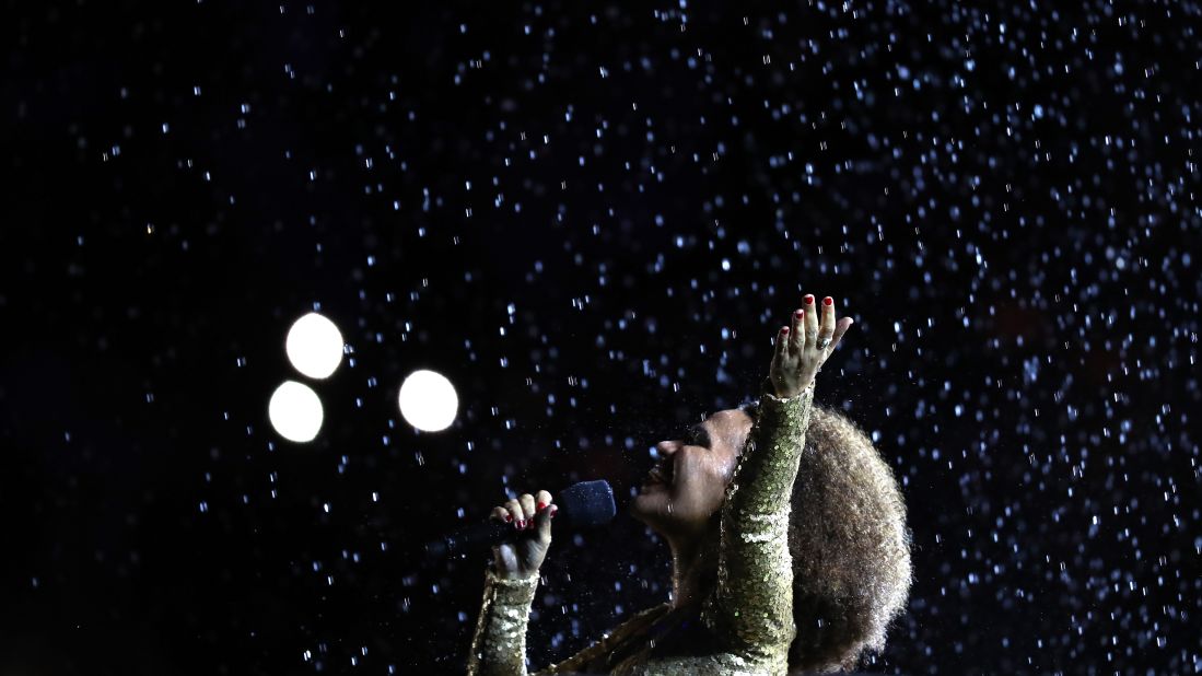 Singer Mariene de Castro performs in front of the Olympic Cauldron before the flame was extinguished.