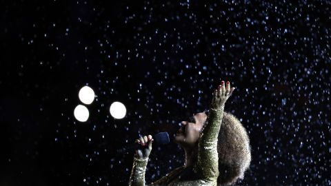 Singer Mariene de Castro performs in front of the Olympic Cauldron before the flame was extinguished.