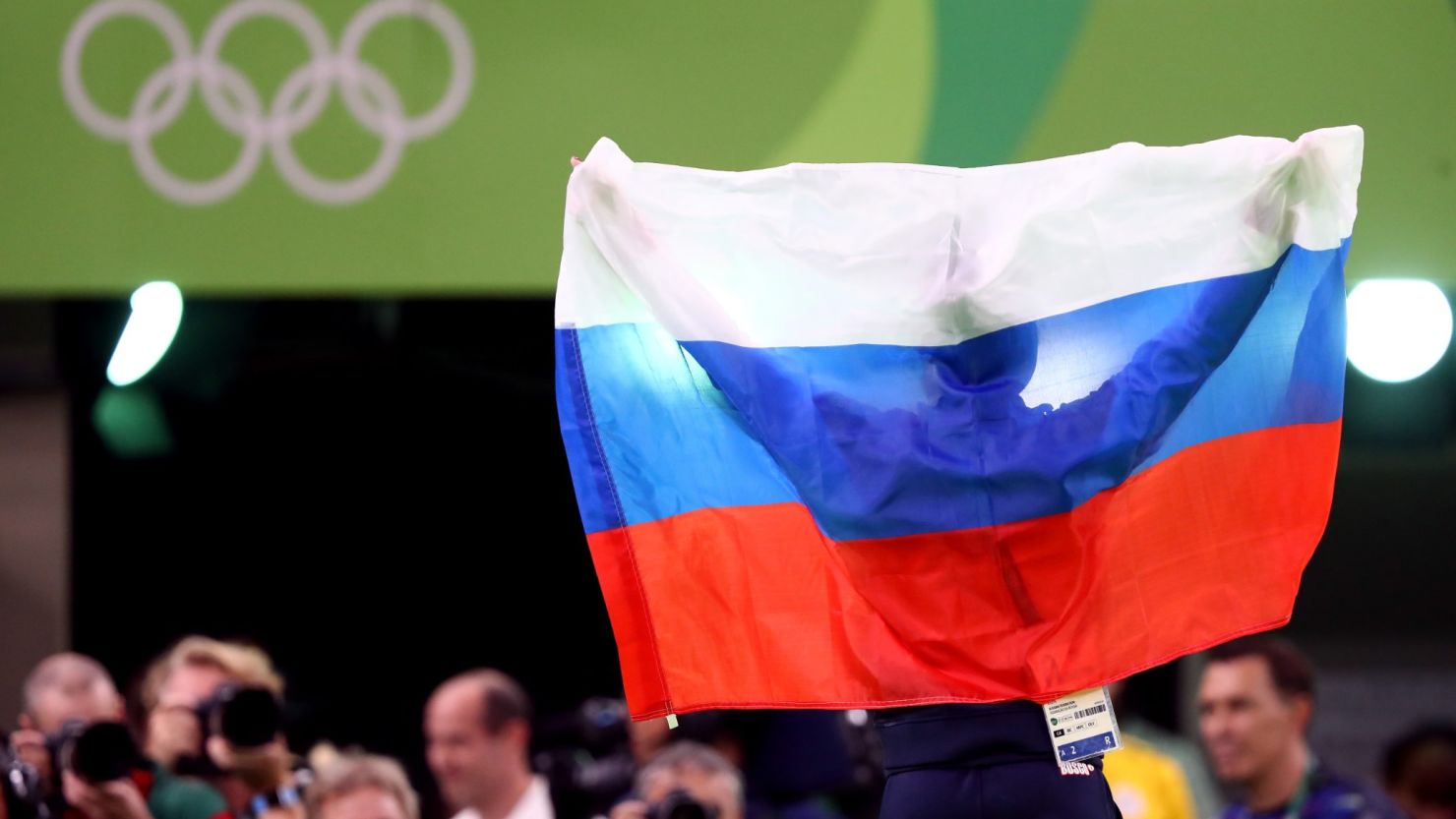 A Russian supporter holds aloft a flag to support the team members competing in Rio.
