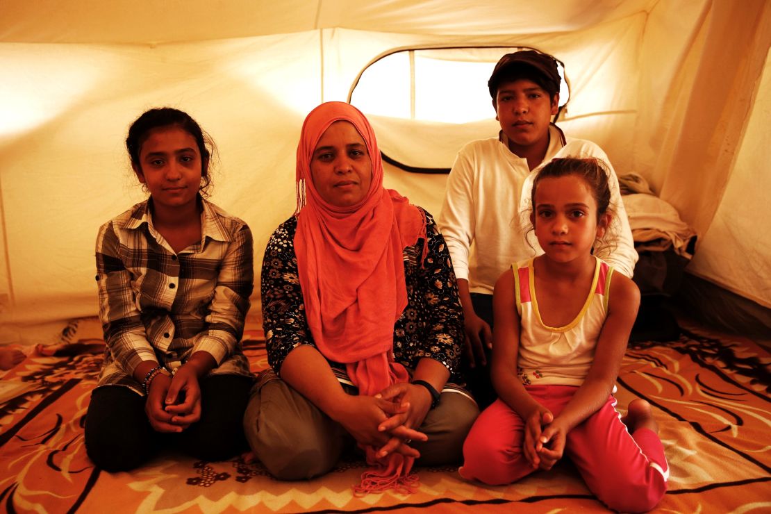 Zalasht's (center) husband was killed by a car bomb in Afghanistan. She is now stranded in Greece with her children. 