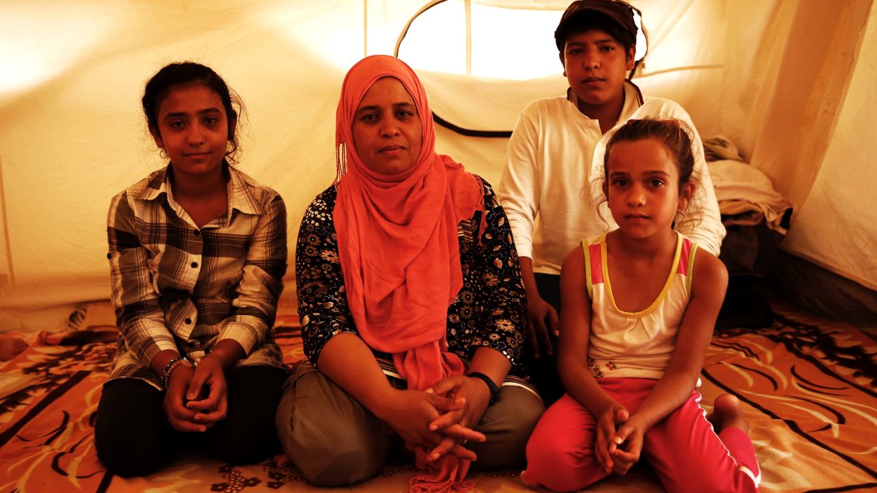 Zalasht's (center) husband was killed by a car bomb in Afghanistan. She is now stranded in Greece with her children. 