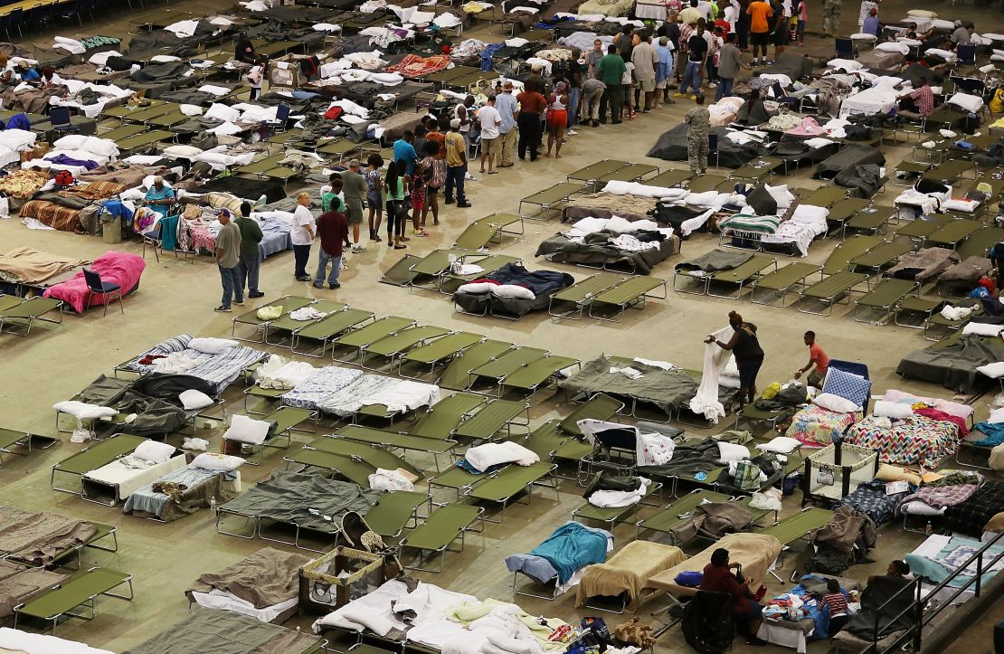 Evacuees take advantage of the shelter setup in the The Baton Rouge River Center arena.