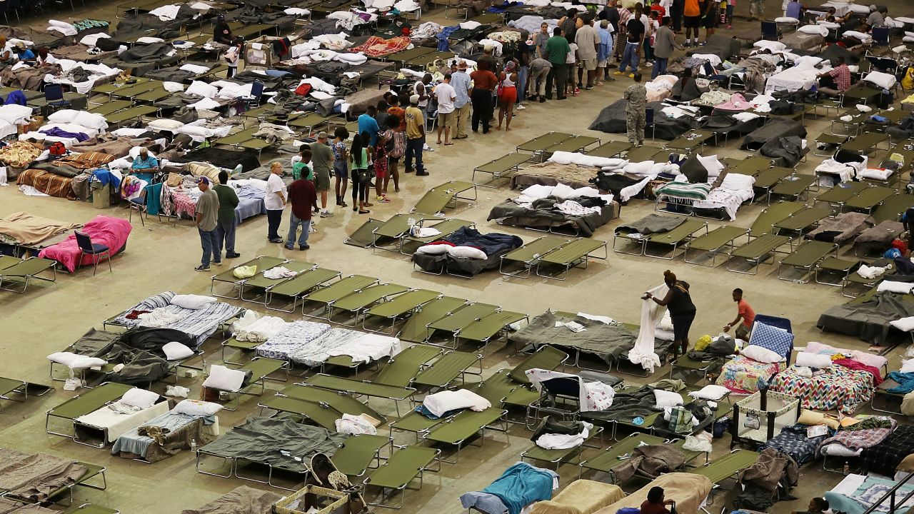 Evacuees take advantage of the shelter setup in the The Baton Rouge River Center arena.
