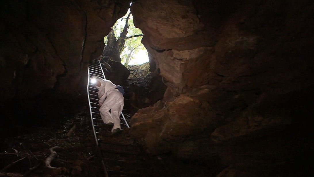 Two researchers carefully descend into Grootboom cave, located just miles away from the densely populated city of Johannesburg in South Africa.