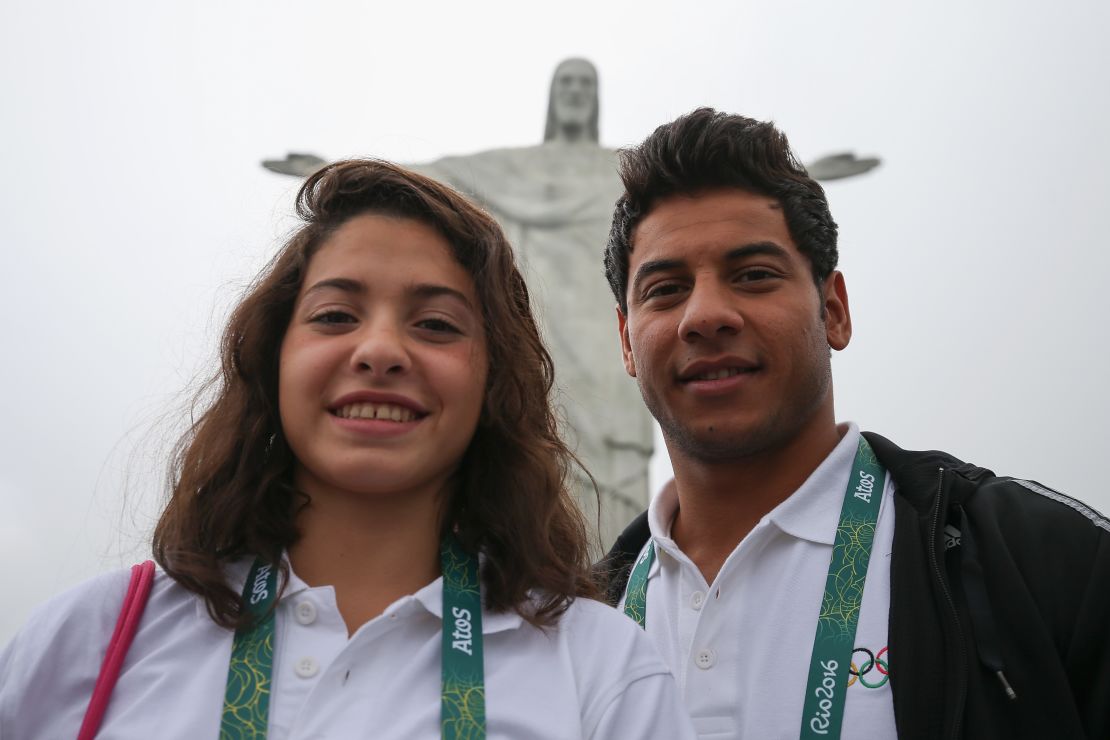 Olympic refugee team swimmers Yusra Mardini and Rami Anis pose for a photo in front of the Christ the Redeemer statue on in Rio de Janeiro, Brazil.