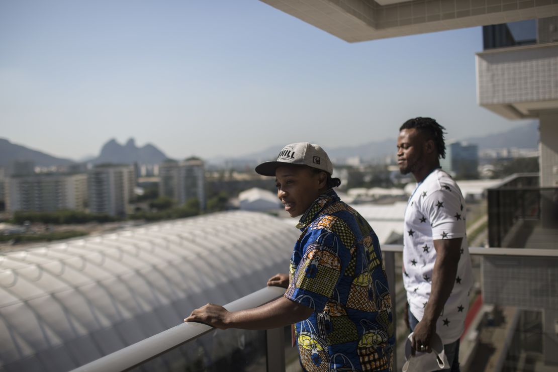 Refugees and judo athletes from the Democratic Republic of Congo Yolande Mabika, center, and Popole Misenga, right, take in the view from their future apartment at the Olympic Village.