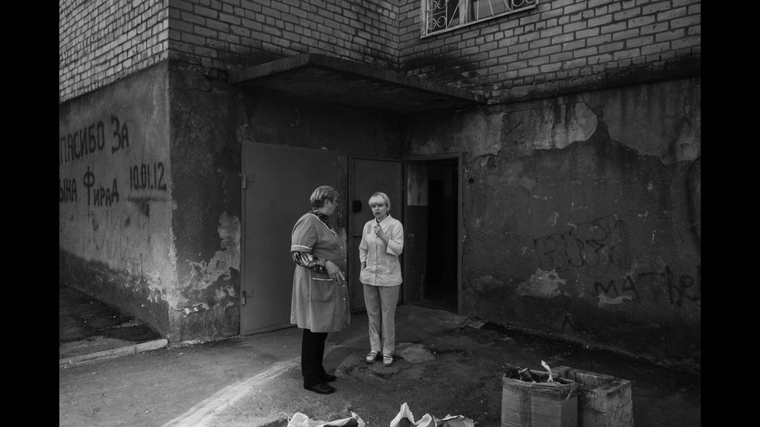 Two nurses take a break outside of a maternity ward in Kramatorsk, Ukraine. According to photographer Pascal Vossen and writer Nils Adler, the ward had no functioning toilets -- a sign of its poor condition.