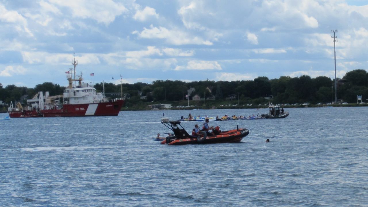 A Canadian Coast Guard rescue vessel assists floaters in need on the St. Clair River.