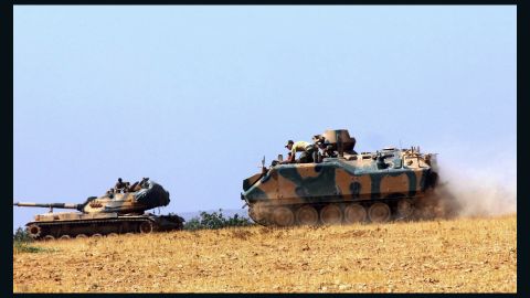 Turkish military vehicles move near the Syrian border in Karkamis on Tuesday.