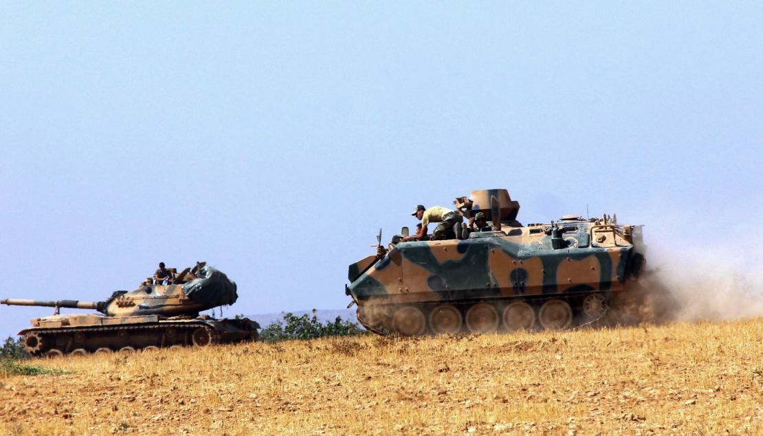 Turkish military vehicles move near the Syrian border in Karkamis on Tuesday.