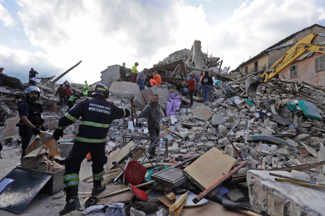 Rescuers search for survivors in the rubble in Amatrice. 