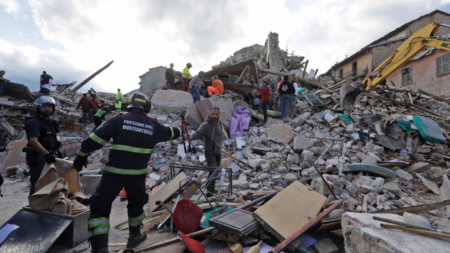 Rescuers search for survivors through the rubble of collapsed buildings on Wednesday in Amatrice, Italy. 