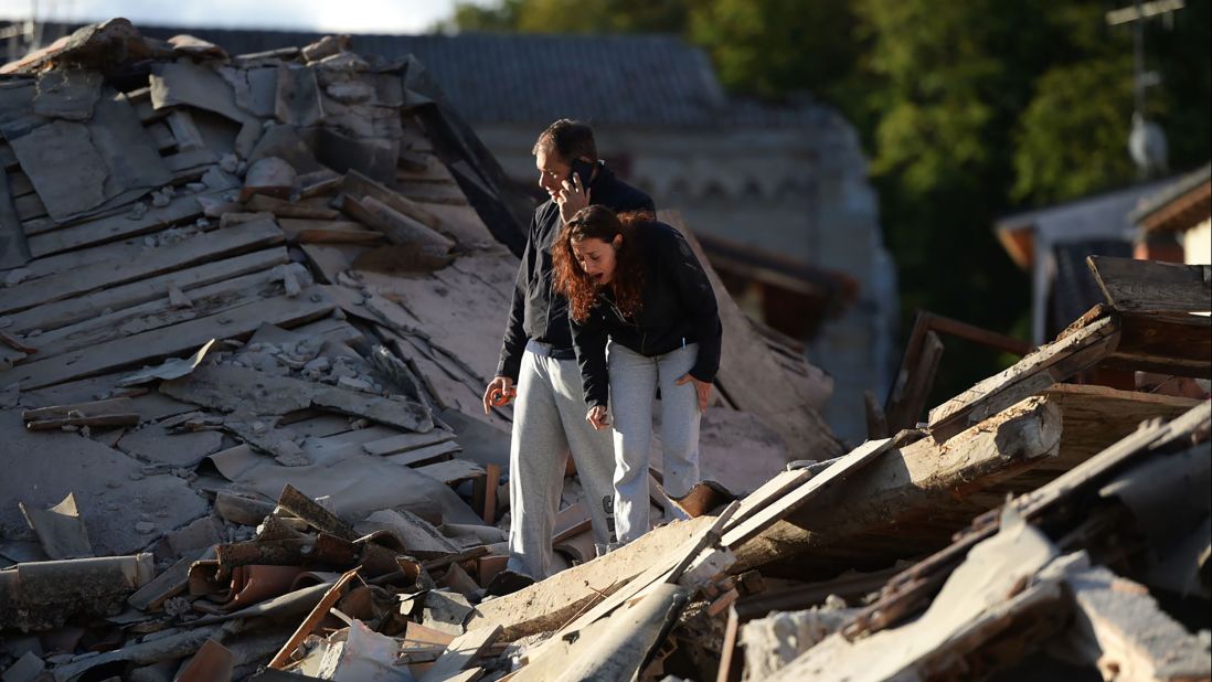 Residents take in the damage in Amatrice.