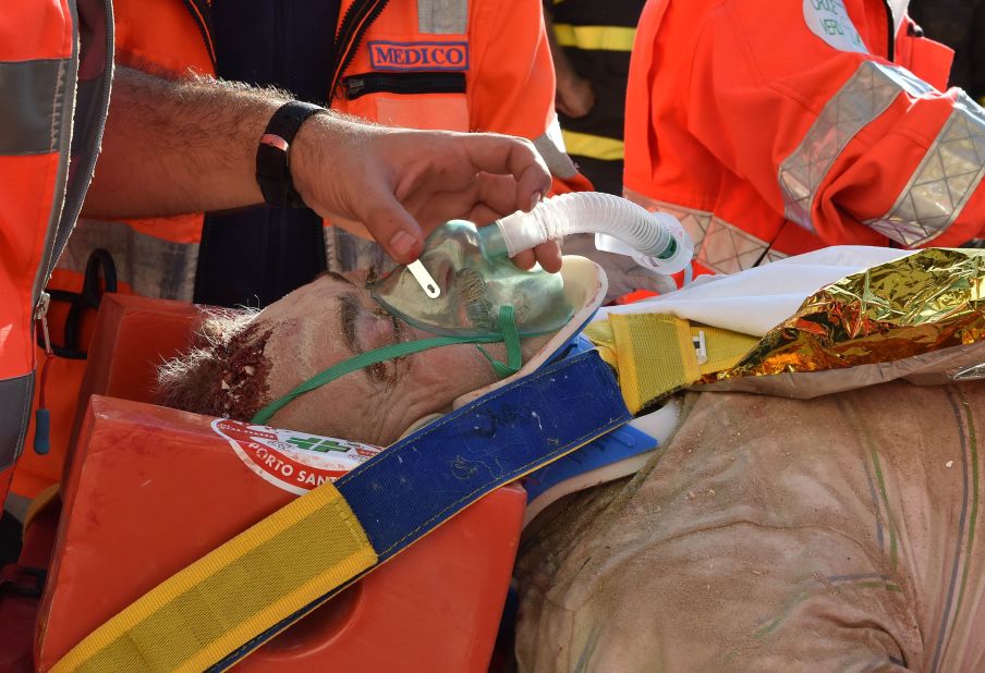 Rocco Girardi receives treatment after being rescued from the rubble in Arquata del Tronto on August 24.