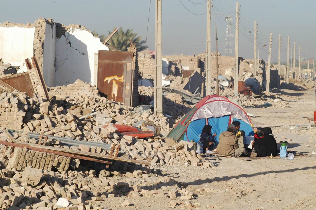 Quake victims sit outside a tent after an earthquake decimated the Iranian city of Bam. More than 30,000 people were killed. 