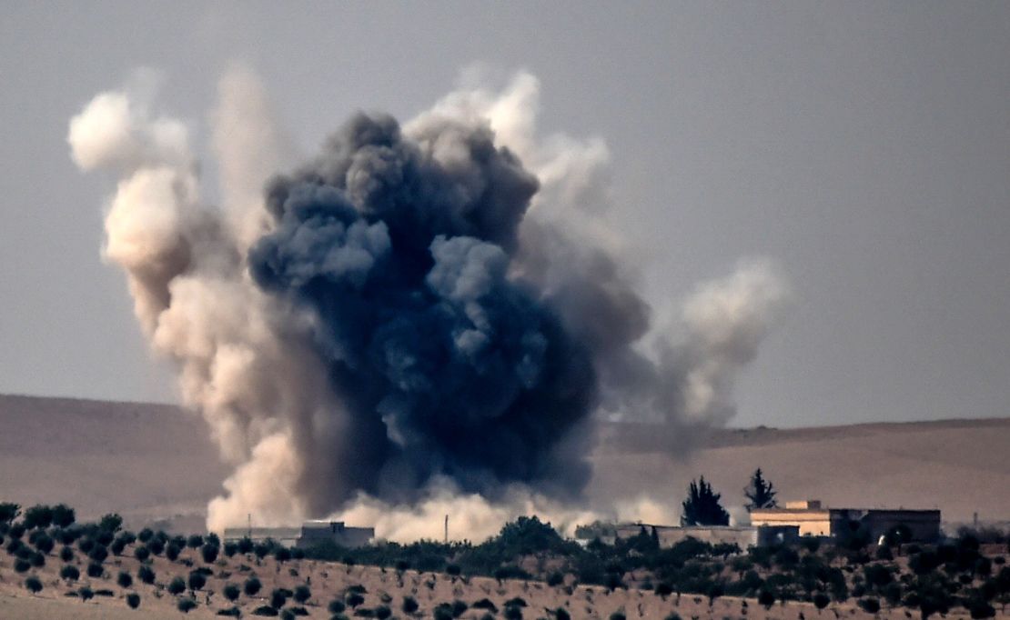 Smoke billows following air strikes by a Turkish Army jet fighter on the Syrian Turkish border village of Jarabulus.