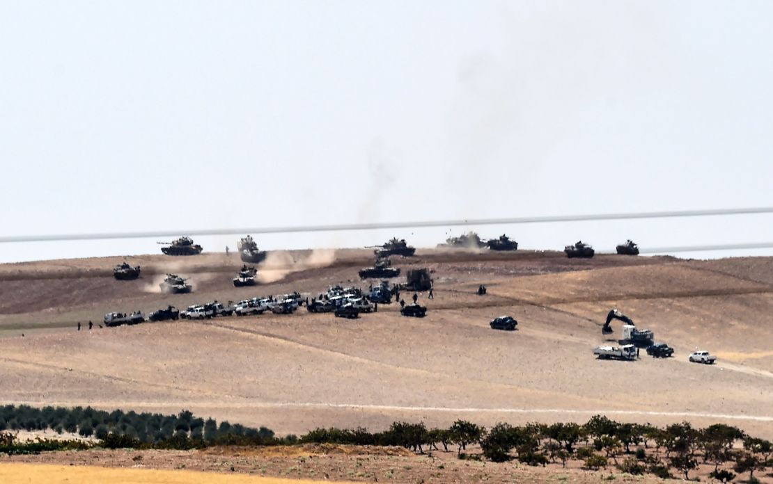 Turkish army tanks and pro-Ankara Syrian opposition fighters two kilometres west from the Syrian/Turkish border town of Jarabulus.