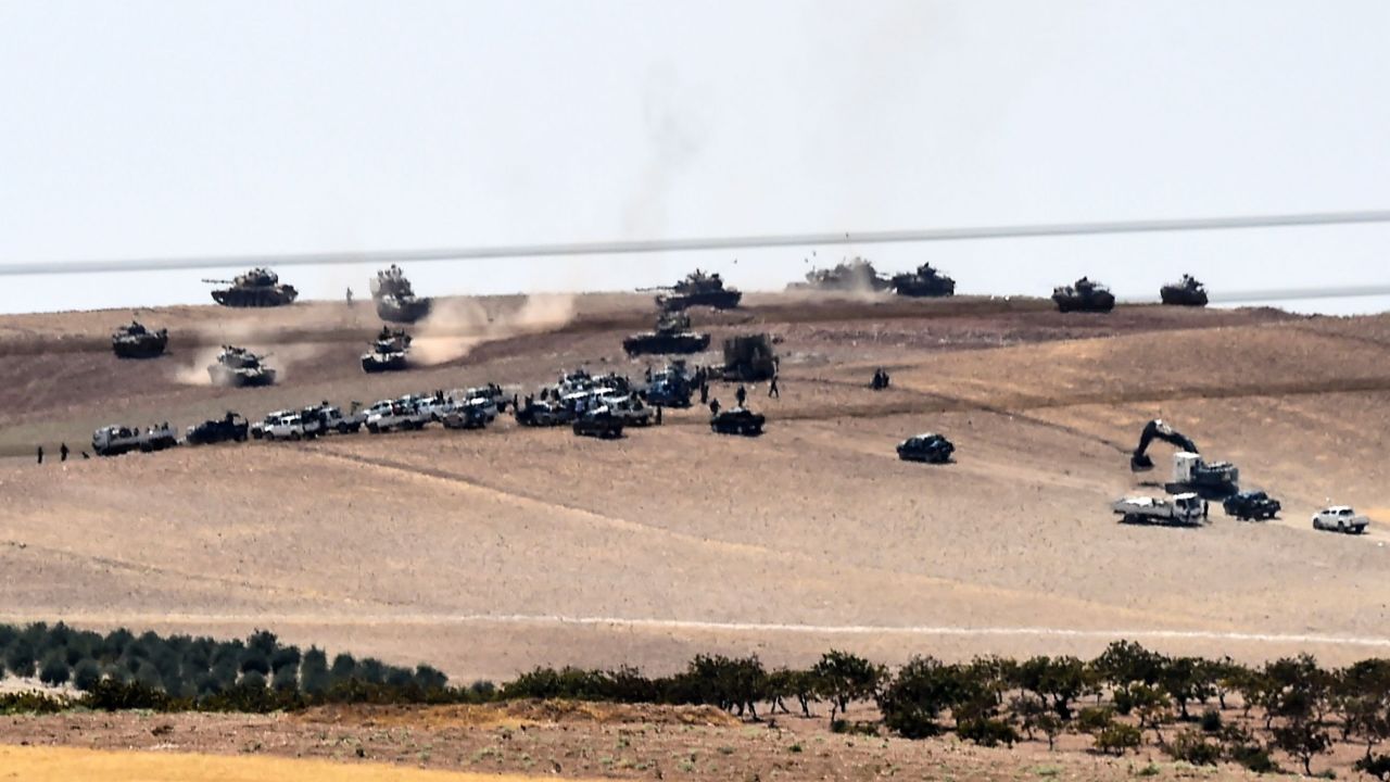 Turkish army tanks and pro-Ankara Syrian opposition fighters two kilometres west from the Syrian/Turkish border town of Jarabulus.