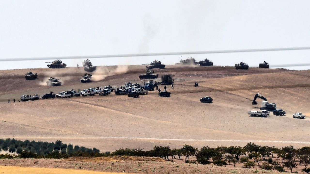 Turkish tanks and allied Syrian rebels move along the border Wednesday.