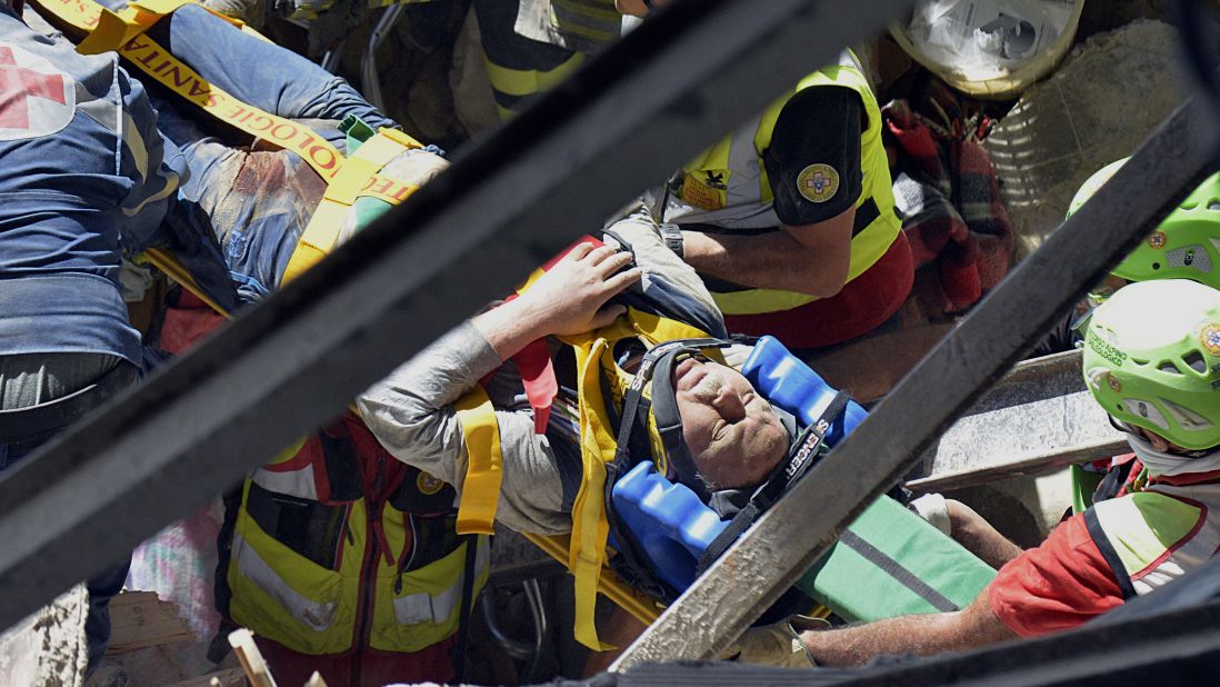 A man is pulled alive from the rubble.
