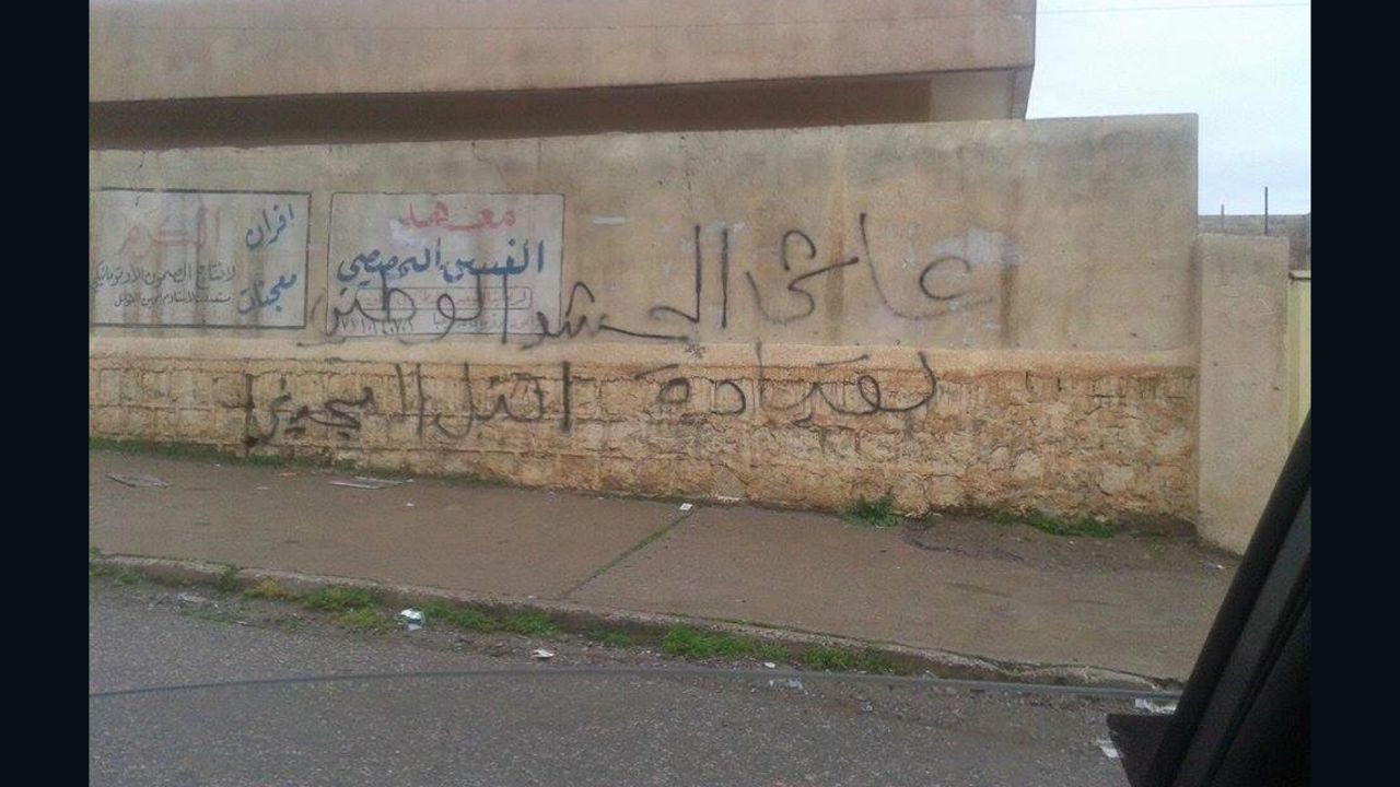 The graffiti on this wall in Mosul reads: "Long live national Mobilization."