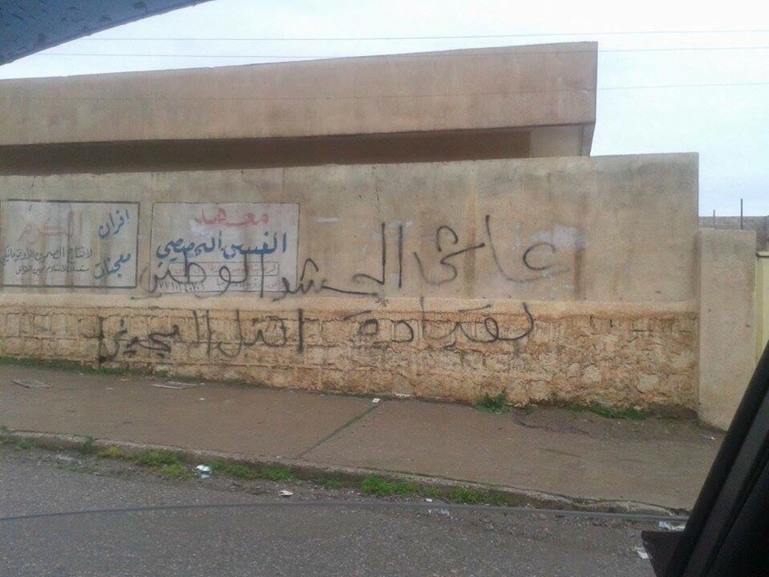 The graffiti on this wall in Mosul reads: "Long live national Mobilization."