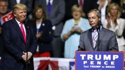 Republican Presidential nominee Donald Trump, left,  listens to United Kingdom Independence Party leader Nigel Farage speak during a campaign rally at the Mississippi Coliseum on August 24, 2016 in Jackson, Mississippi.