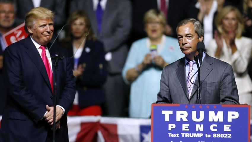 Republican Presidential nominee Donald Trump, left,  listens to United Kingdom Independence Party leader Nigel Farage speak during a campaign rally at the Mississippi Coliseum on August 24, 2016 in Jackson, Mississippi. 